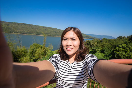 Asian Young Female Tourist Makes Selfie