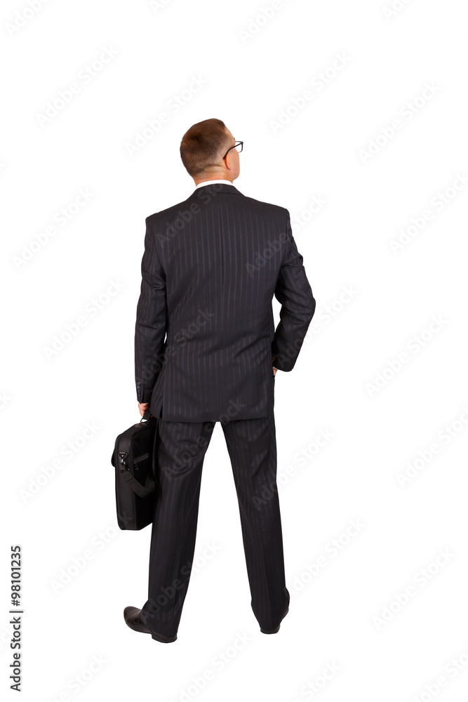 Wall mural back view of a walking business man with a notebook case and looking to a side, full length portrait