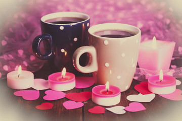 Two cups on table on lights background