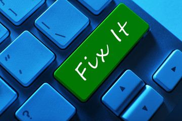 Close-up of laptop keyboard with color button and Fix it text