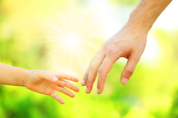 Hands of father and son holding each other