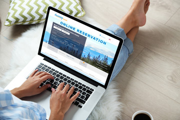 Woman using laptop to book hotel online