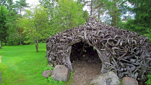 A small hut made in small branches of trees. It is located in the middle of the hill in Enumagi Estonia