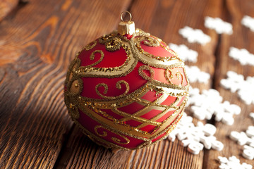 Christmas baubles and snowflakes on wooden background
