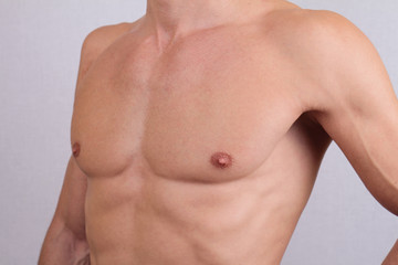 Fototapeta premium Close up of muscular male torso and chest hair removal. Male Waxing
