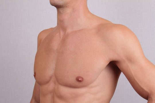 Close up of muscular male torso and chest hair removal. Male Waxing