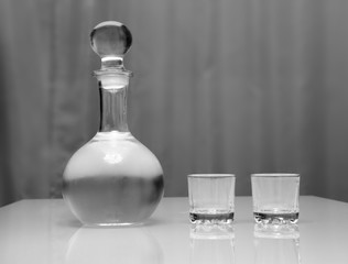 decanter and two glasses with vodka standing on table