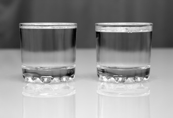 two glasses with vodka on table