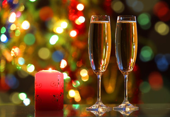 glasses with champagne and candle