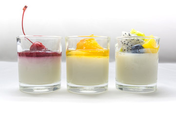 yogurt penna cotta with various fruits topping in glassware