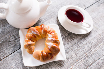 Cup of fruit tea with croissant