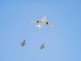 Ilyushin Il-78 (Midas) four-engined aerial tanker demonstrates refueling of 2 Mikoyan MiG-31...