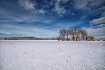 Fototapeta na wymiar Winter scenery of frozen lake in city park