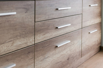Wooden kitchen drawers with silver handles
