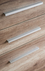 Wooden kitchen drawers with silver handles