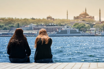 Girls Sitting At The Coastline, Istanbul, Turkey