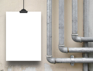 Single paper sheet frame hanged with clothes pin on concrete wall with metal grey pipes background