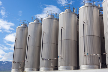 Giant industrial tanks on the bright blue sky