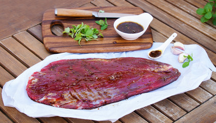 raw flank steak in the marinade. style vintage. top view. selective focus