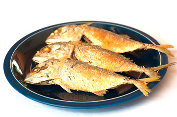 Fried Mackerel on dish ready to be served over white background