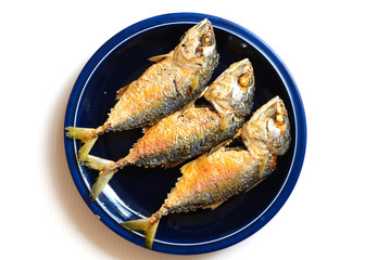 Fried Mackerel on dish ready to be served over white background