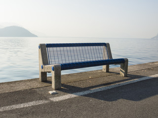 Empty bench near the river of a lake