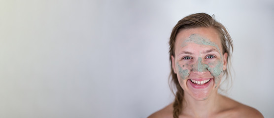 Beautifu toplessl woman with facial mask having her eyes closed.