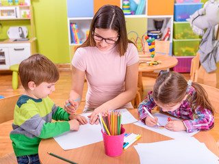 kindergarten classroom teacher with kids

