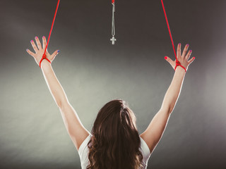Tied woman forced to worship. Fake faith religion.