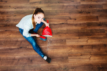 Cleaning woman sweeping wooden floor