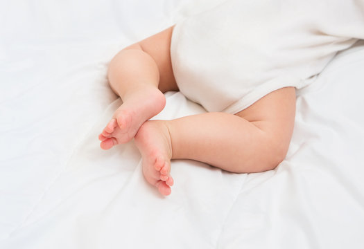 Newborn Baby legs on the bed