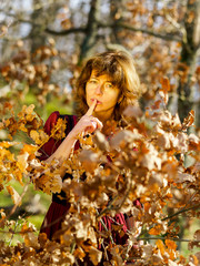 Woman in red dress portrait, autumnal forest