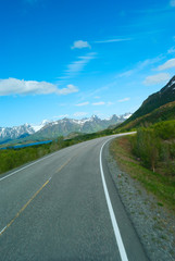 Asphalt road to Norvegian mountains in summer clear day