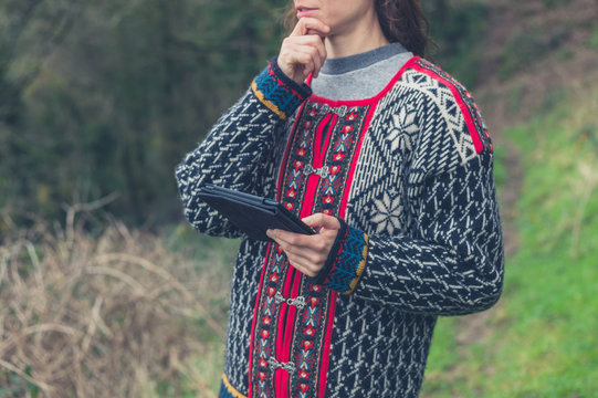 Woman using tablet in nature