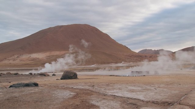 El Tatio geysers steam at sunrise at the famous El Tatio geyser valley at 4320 meters above sea level,  Chile.