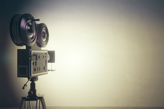 Old style movie camera with white wall, vintage photo effect