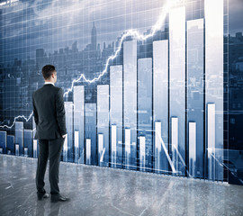 Businessman looking at the scoreboard with business chart and ci