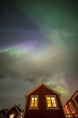 Aurora borealis above rorbuer in Hamnoy village, Lofoten, Norway