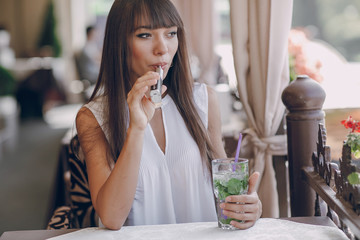 girn in cafe with E-Cigarette