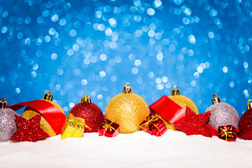 christmas ornament in snow on glitter background