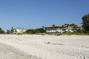 Houses on tropical beach with white sand