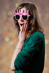 Female wearing funny sunglasses making a sily expression 