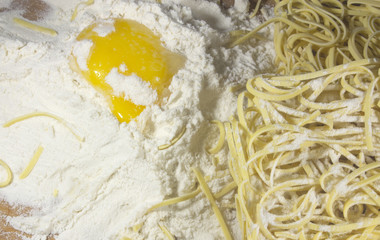 Asian Noodle and Egg with Flour on Wooden Table Closeup
