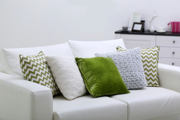 Sofa with colorful pillows in room