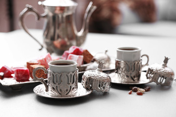 Antique tea-set with Turkish delight on table close-up