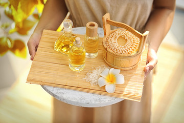 Female hands with tray of spa products, at spa salon