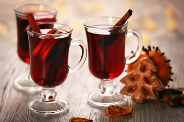 Mulled wine with cookies on wooden table