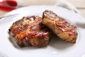 Roasted beef fillet on plate, on wooden background