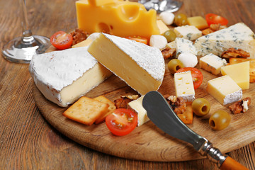Cheese for tasting on wooden background