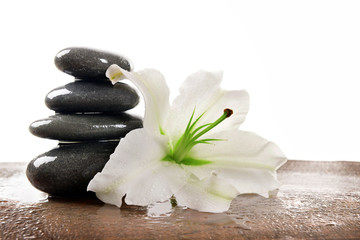 Spa stones with lily, isolated on white